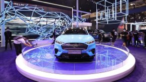 A Ford Mustang Mach-E on display at an auto show