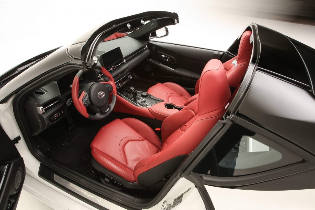 Interior view of a white Toyota Supra with the Sport Tops removed.