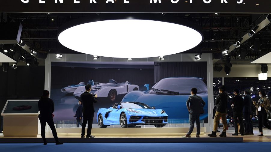 Visitors are attracted by a Chevrolet Corvette Stingray at the booth of General Motors at the Automobile exhibition area