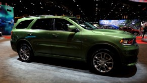 A green Dodge Durango on display at an auto show