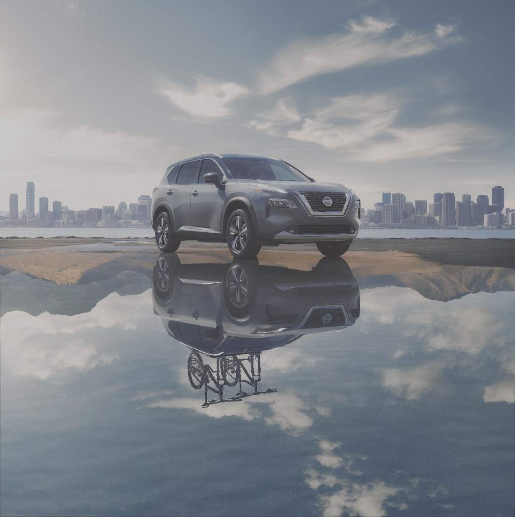 2021 Nissan Rogue parked on a sandbar with its reflection shown in the water