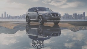 2021 Nissan Rogue parked on a sandbar with its reflection shown in the water