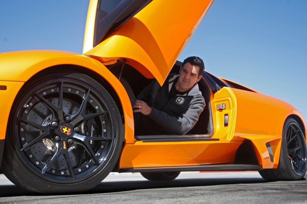 Black HRE aftermarket wheels on an orange Lamborghini