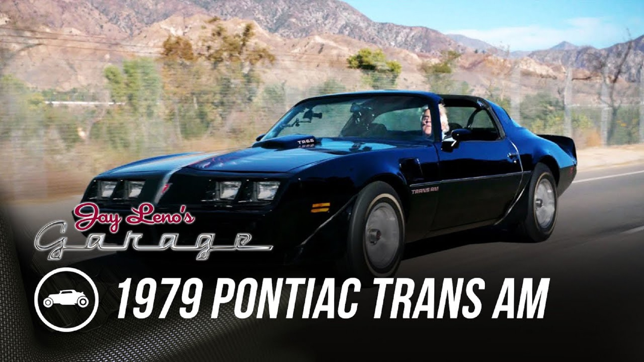 Jay Leno driving a black 1979 Pontiac Trans Am