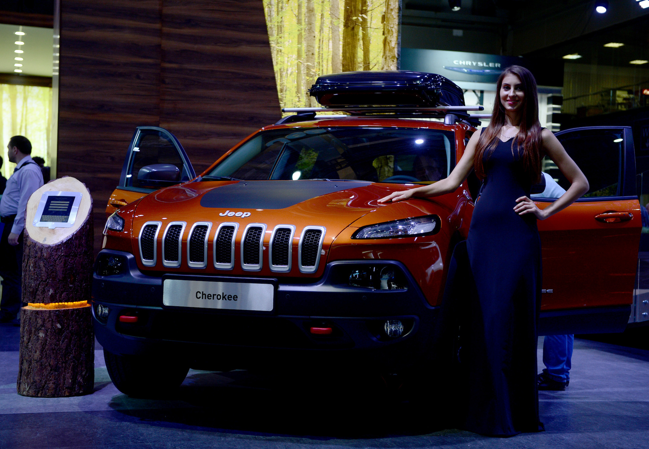 A model poses next to Cherokee model of Jeep during the Moscow International Motor Show 'Autosalon 2014