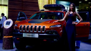 A model poses next to Cherokee model of Jeep during the Moscow International Motor Show 'Autosalon 2014