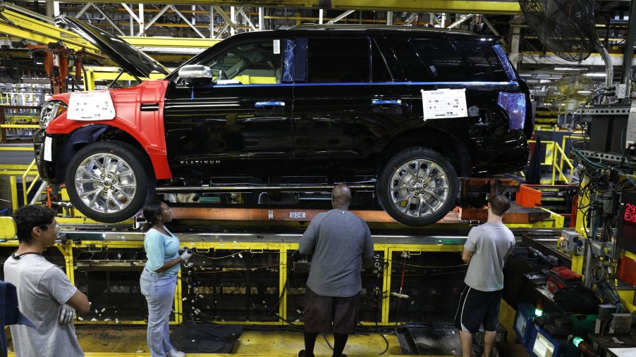 Workers assemble a Ford Expedition