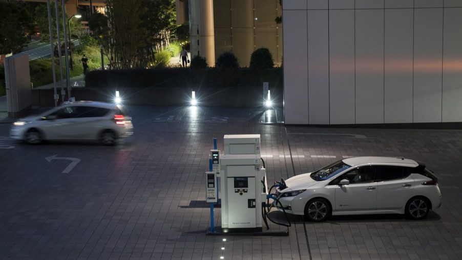 A Nissan Motor Co. Leaf electric vehicle is charged at the company's headquarters at night on May 27, 2020 in Yokohama, Japan