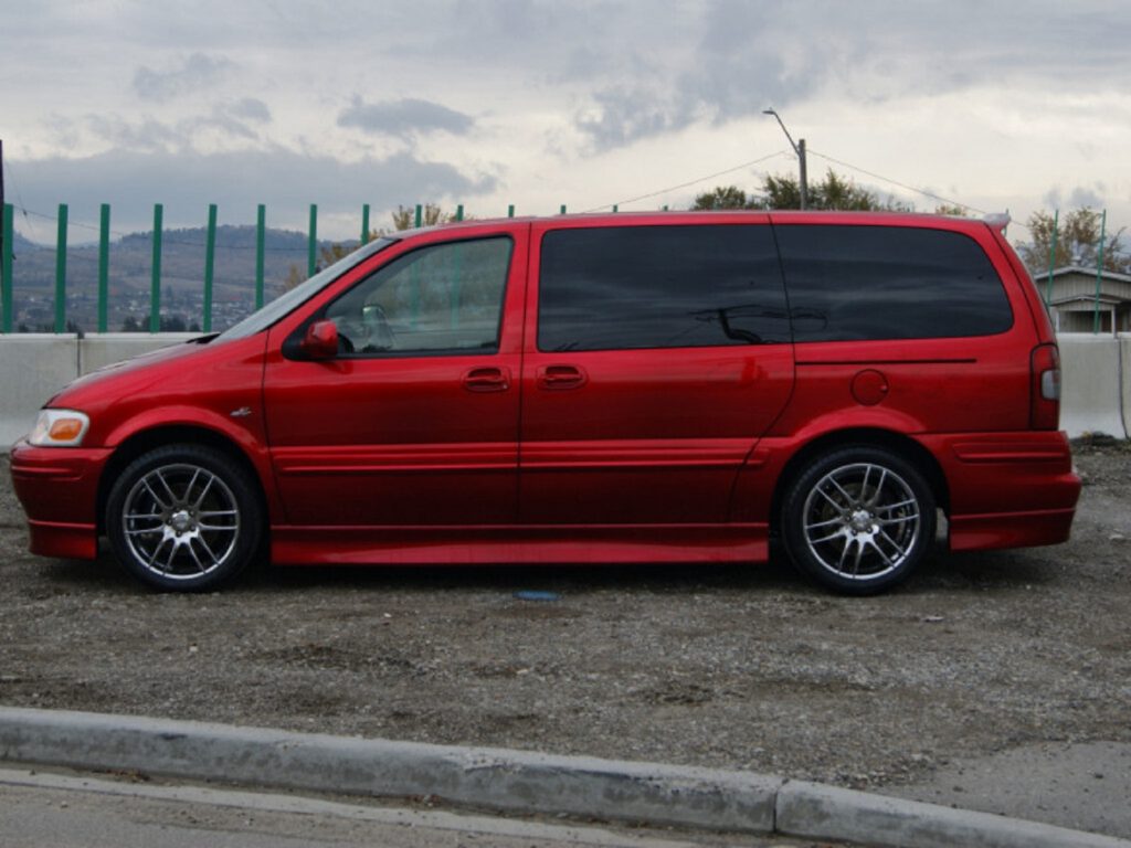 The side view of a red Oldsmobile Silhouette OSV