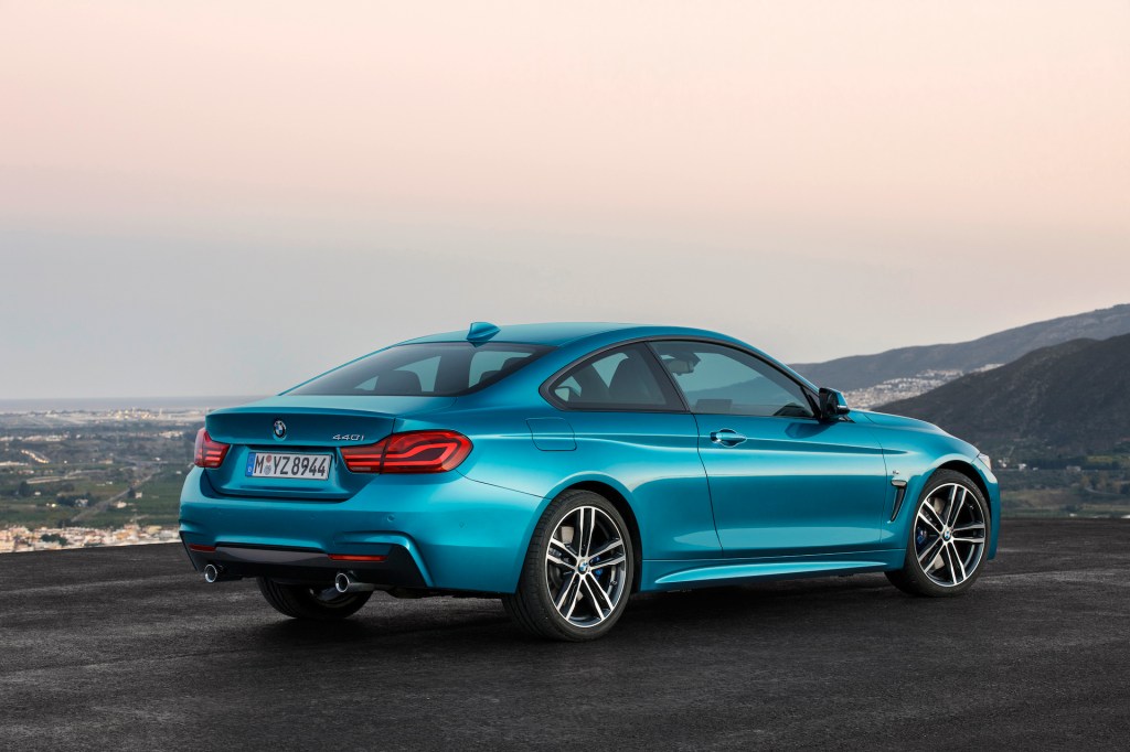 An image of a BMW 4 Series parked on the top of a mountain.