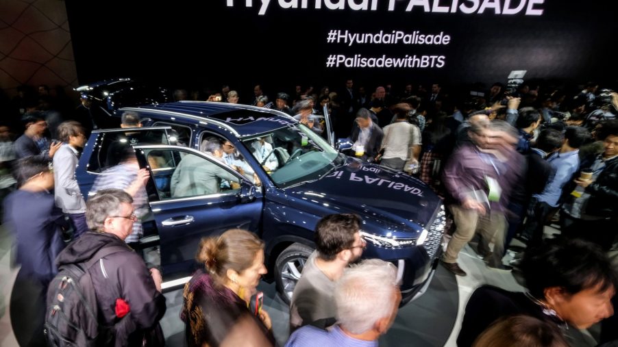 Attendees look at the 2019 Hyundai Palisade SUV during the media preview at the 2018 Los Angeles Auto show