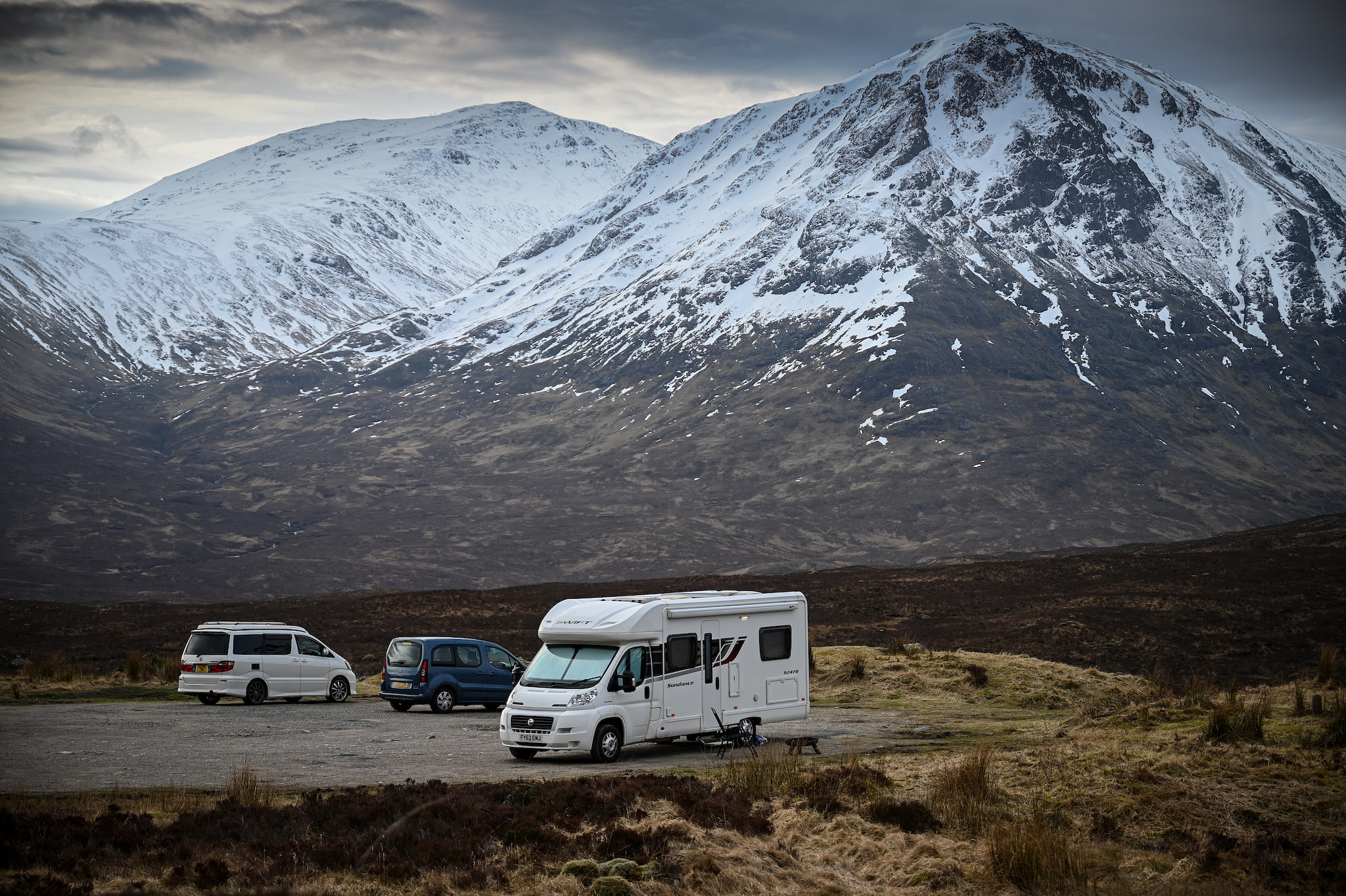 A Class C RV is parked in a car park as members of the public are asked to stop traveling to the Scottish Highlands