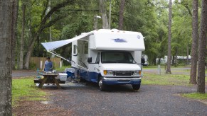A Class C RV parked at a campground