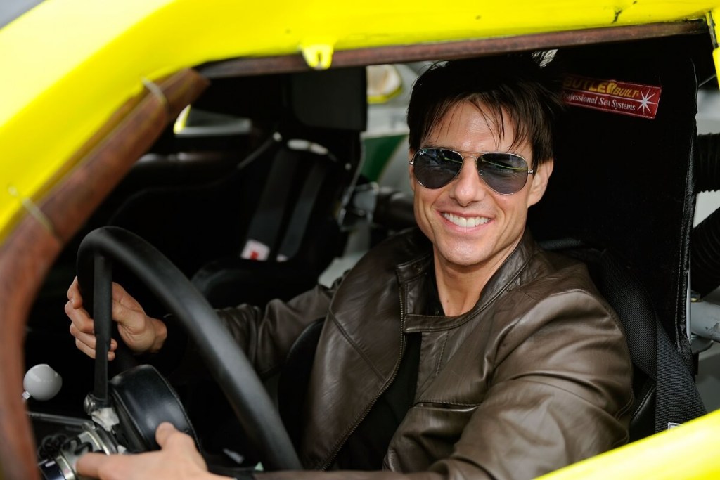 Tom Cruise sits in a NASCAR race car in a tribute to "Days of Thunder."