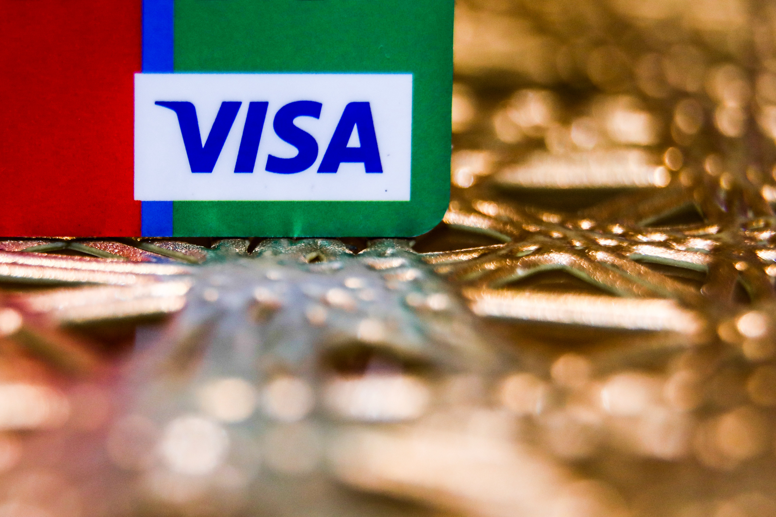 Visa logo is seen on a credit card in this illustration