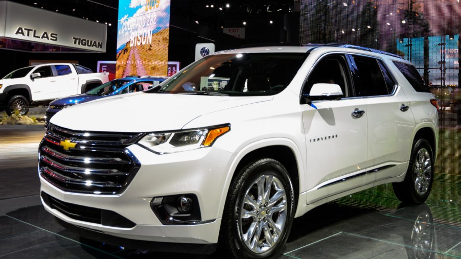 A white Chevy Traverse SUV on display at an auto show