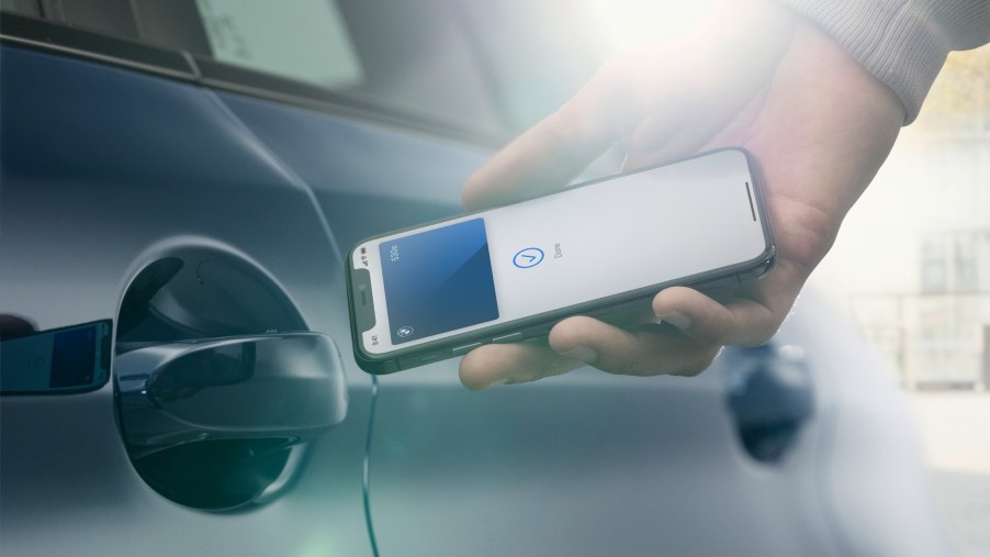 BMW Digital Key app being held up to the driver door handle | BMW