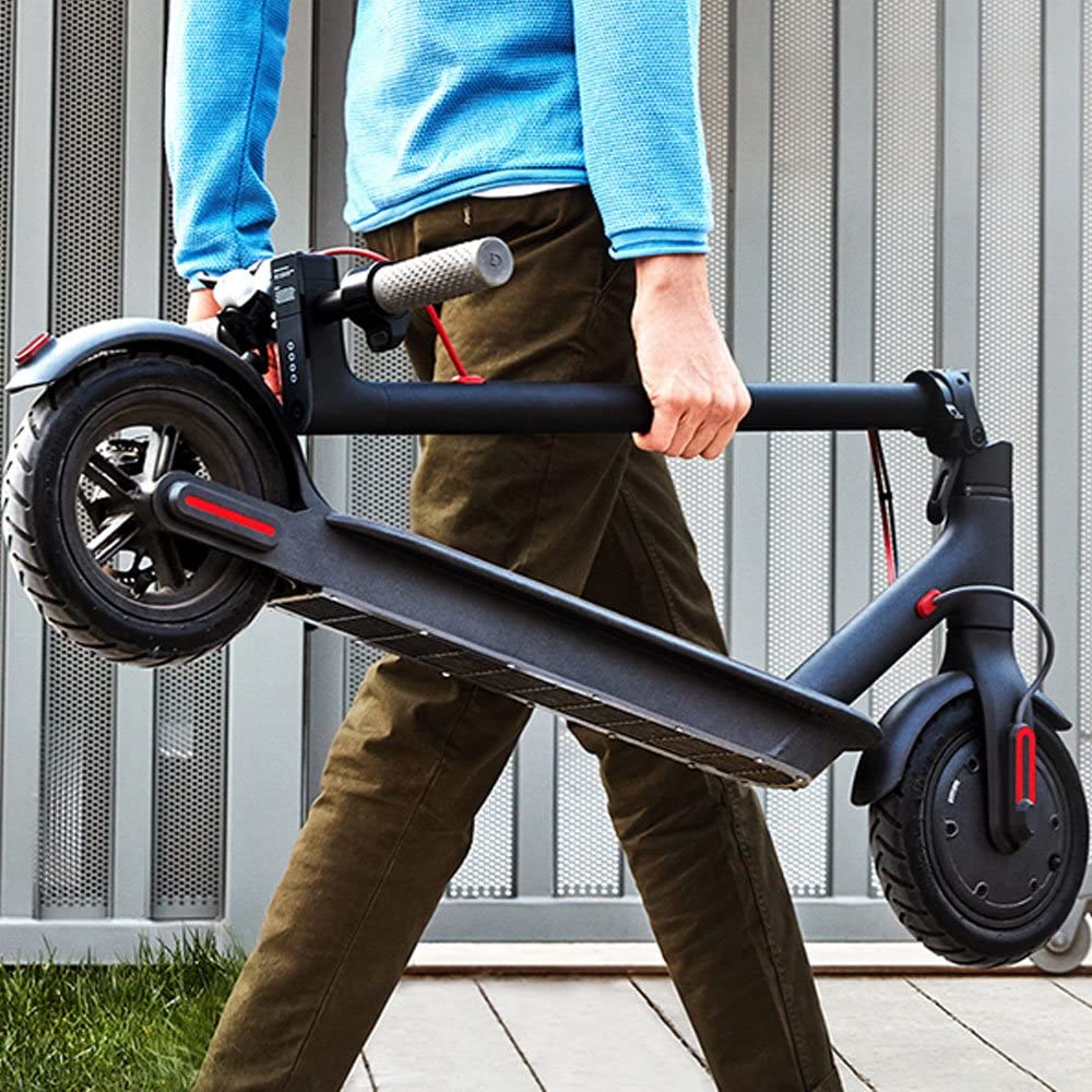 A man carrying a Xiaomi Scooter