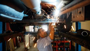 Mechanic removing a catalytic converter | Getty Images