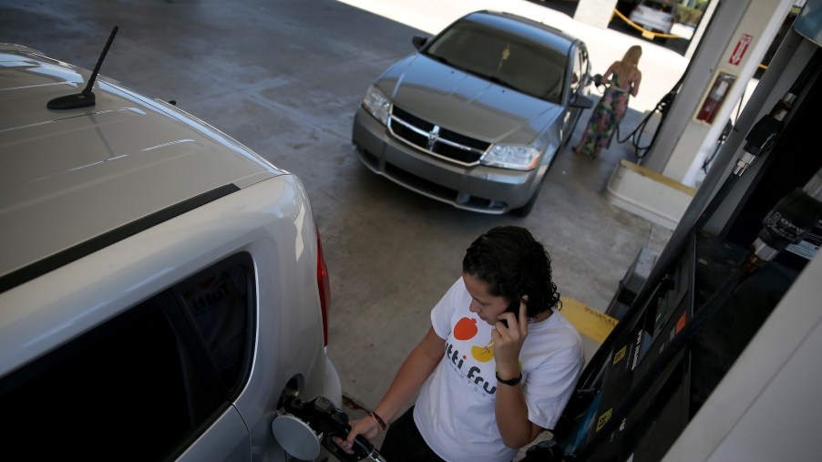 A woman talks on a cell phone at a gas station in Pembroke Pines, Florida, in April 2014.