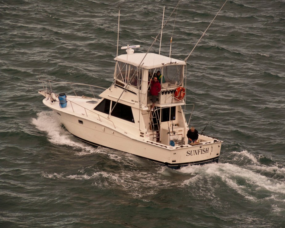 A sport fishing boat cruises on waves