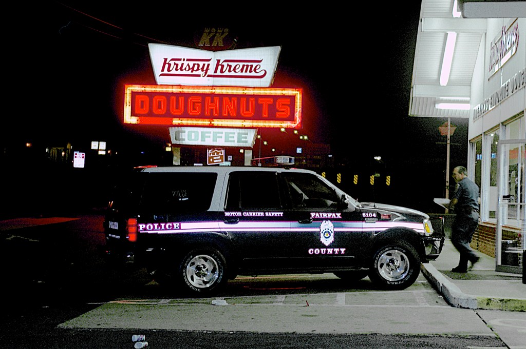 cop car parked outside a krispy kreme