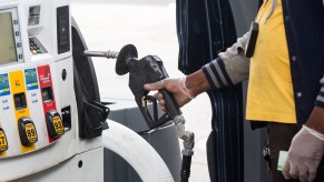 A person grabs a pump nozzle at a Shell gas station in Brooklyn on April 9, 2020.