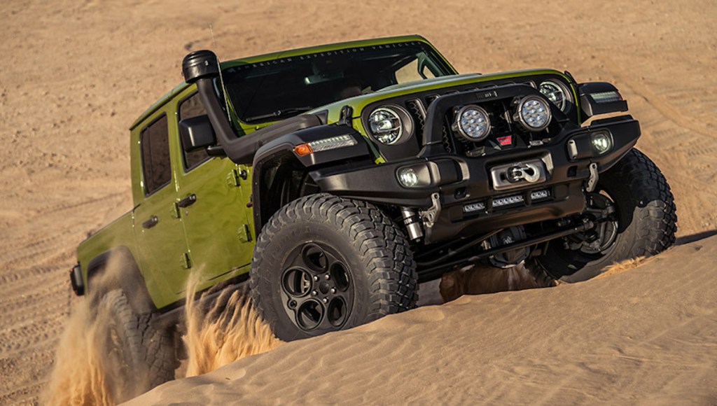 AEV Jeep Gladiator driving up sand mounds 