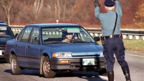 A driver attempts to skirt around Trooper Paul Pierce, who was trying to pull her over for driving in the breakdown lane on Rt. 3 near I-495 in Chelmsford. Trooper Pierce is part of the 3D unit cracking down on aggressive driving.