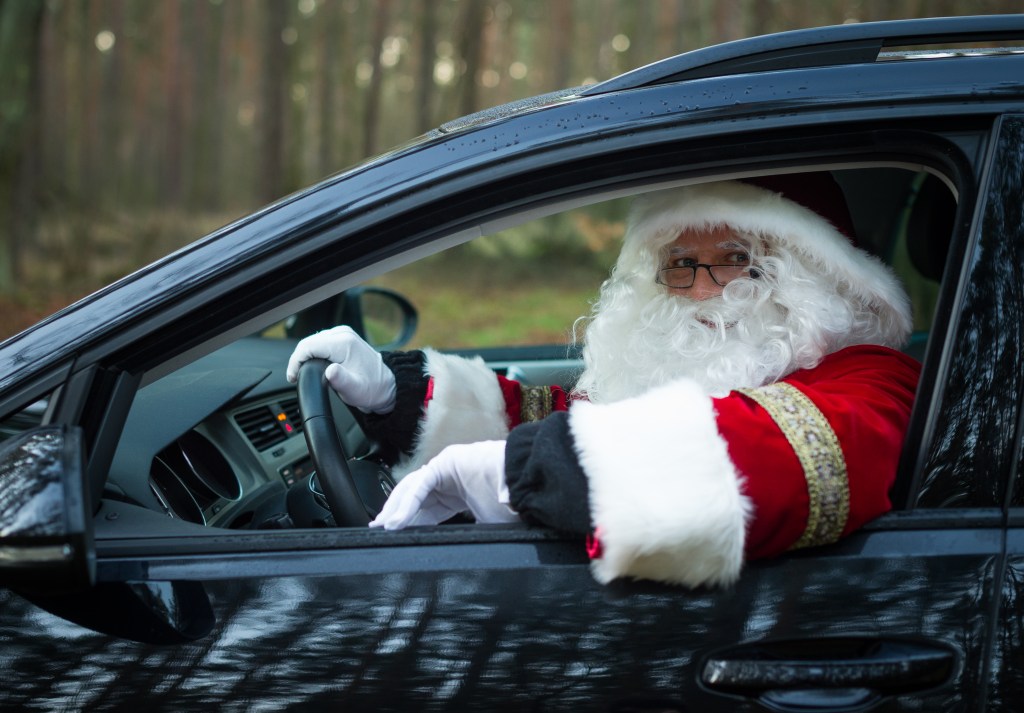 Santa Claus sits in a car