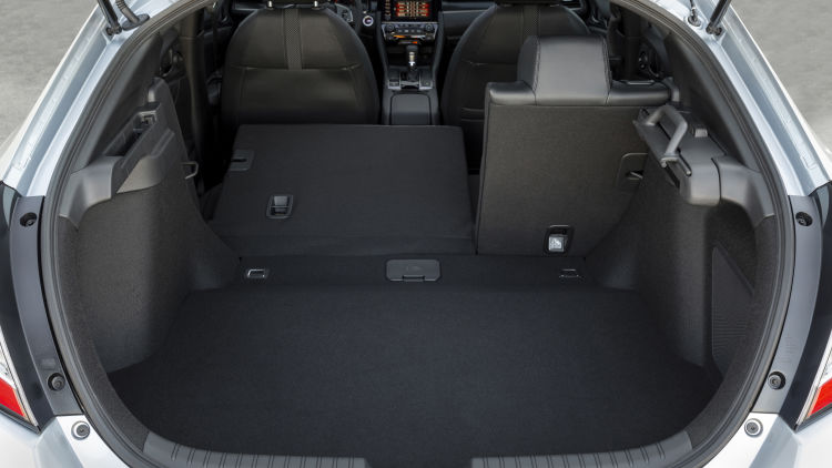 A 2021 Civic Hatchback with the rear seats folded down.