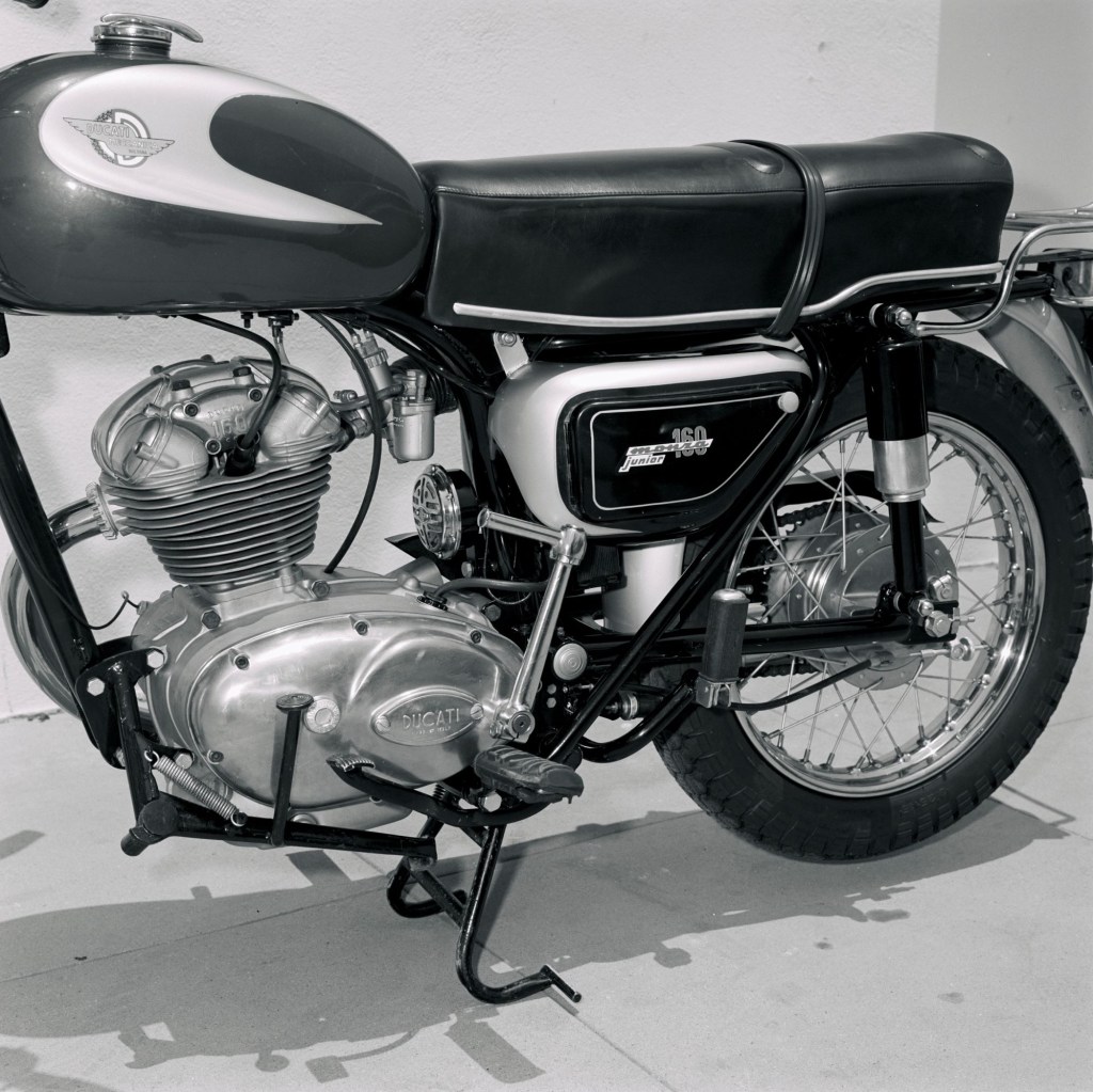 A close-up look at th1 965 Ducati 160 Monza Junior motorcycle engine and kickstarter