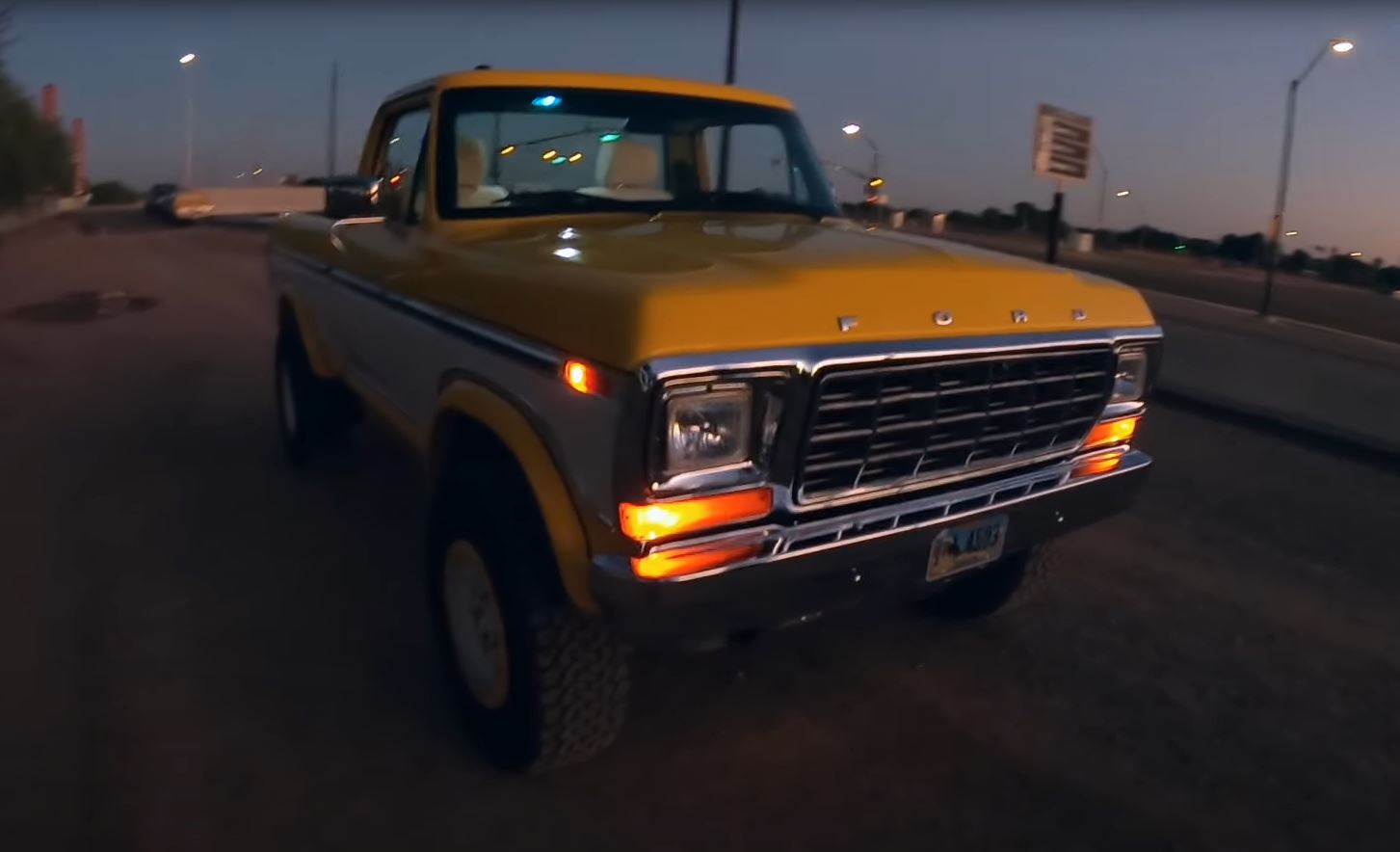 The front passenger side of a yellow and white 1979 Ford F-150 Raptor restomod by Sweet Brothers