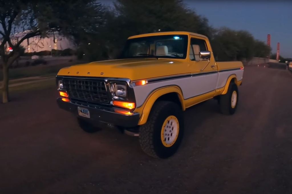 The front driver's side of a yellow and white 1979 Ford F-150 Raptor restomod by Sweet Brothers