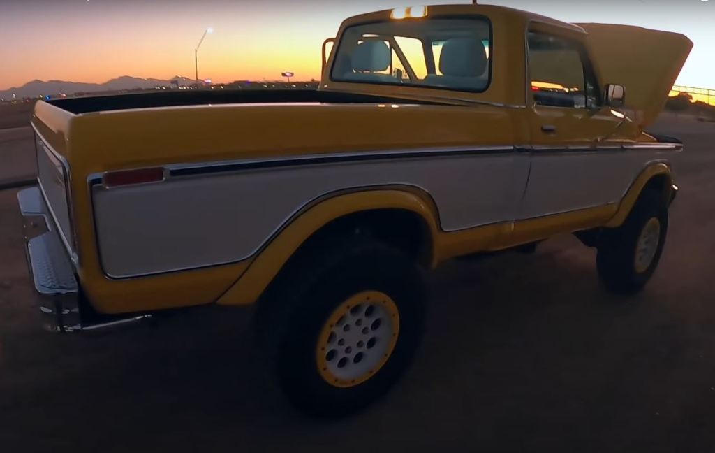 The rear passenger side of a yellow and white 1979 Ford F-150 Raptor restomod by Sweet Brothers