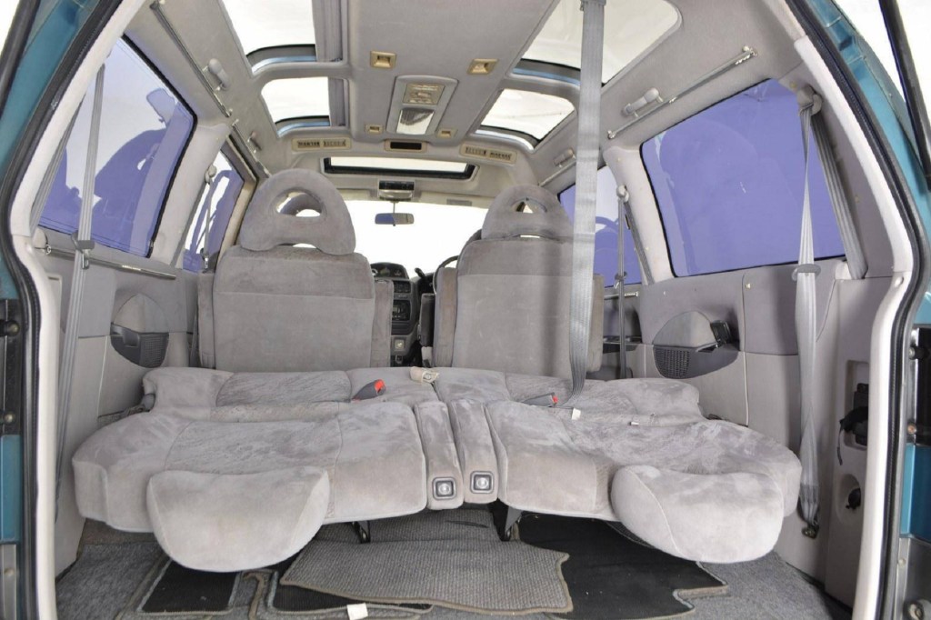 The interior of a 1994 Mitsubishi Delica Space Gear LWB 4x4 interior seen from the rear with the 3rd-row seats folded