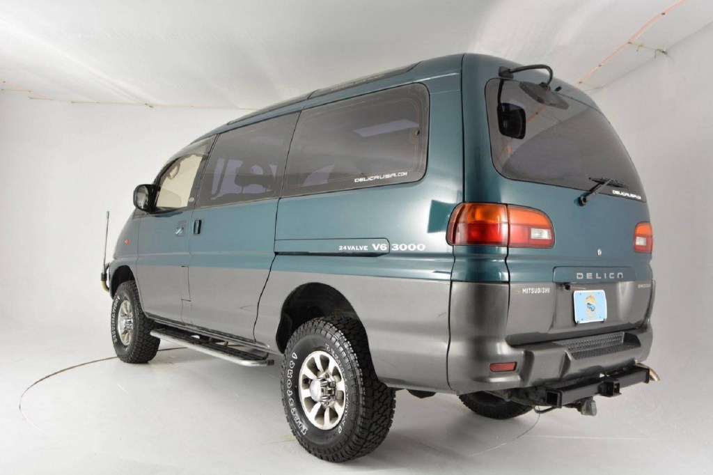 The rear 3/4 view of a turquoise 1994 Mitsubishi Delica Space Gear LWB 4x4