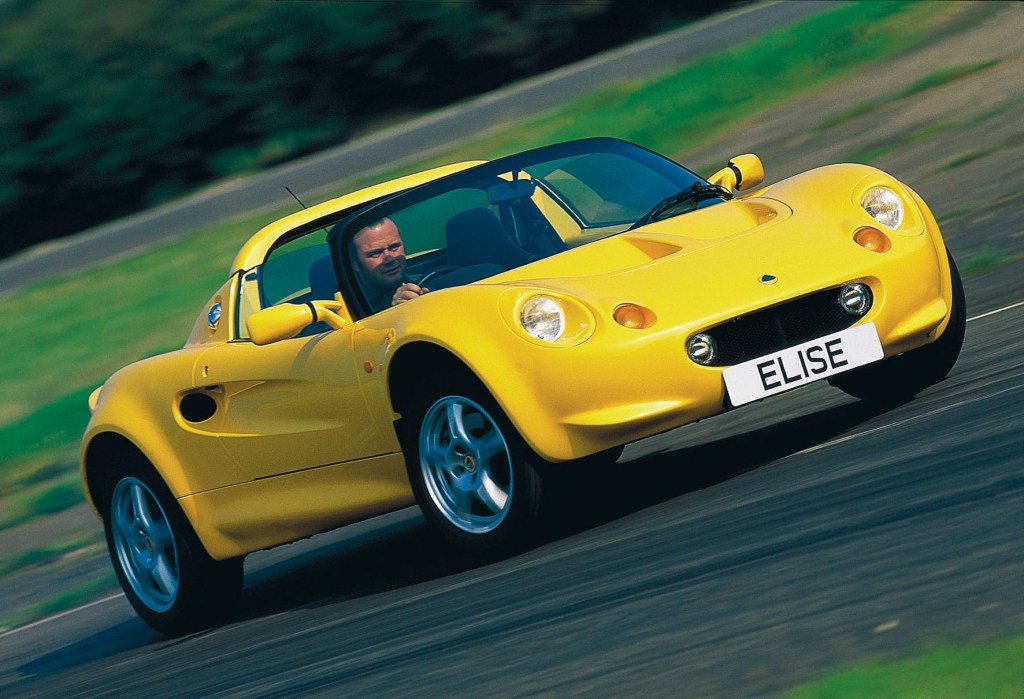 A yellow 1996 Lotus Elise S1 on a racetrack