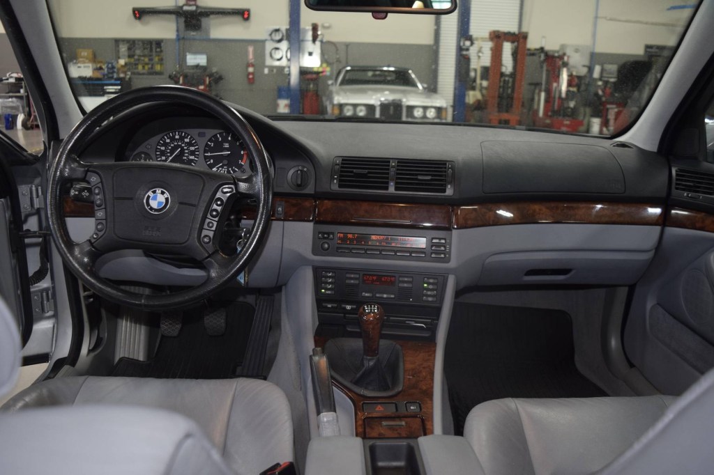 The gray-leather front seats and walnut-trimmed dashboard of a 1997 BMW 540i