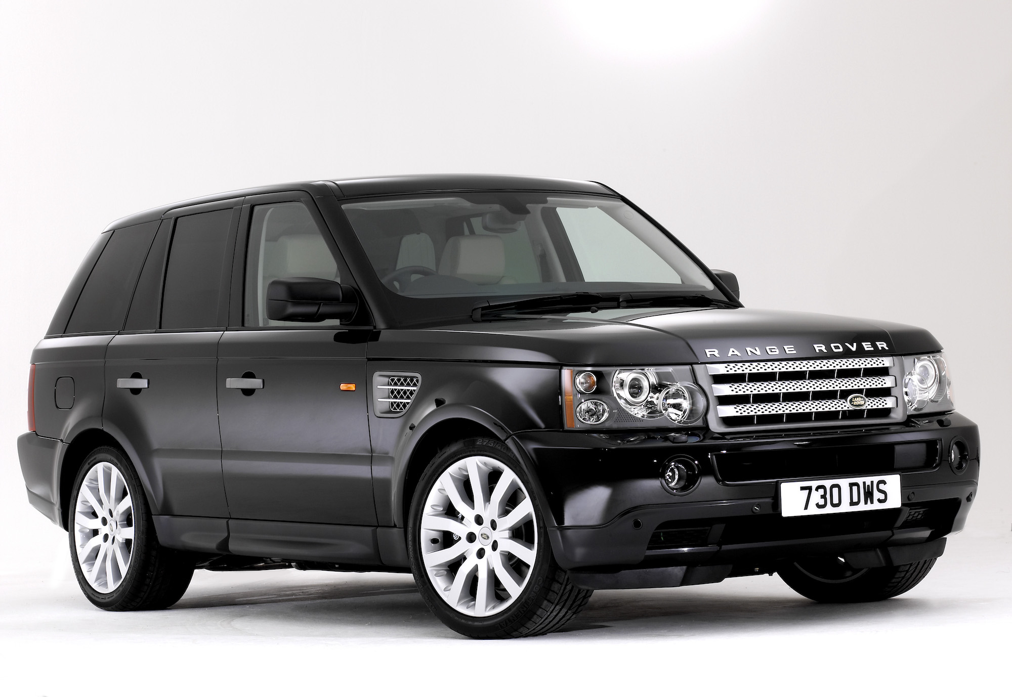 A parked black 2004 Range Rover Sport with tinted windows