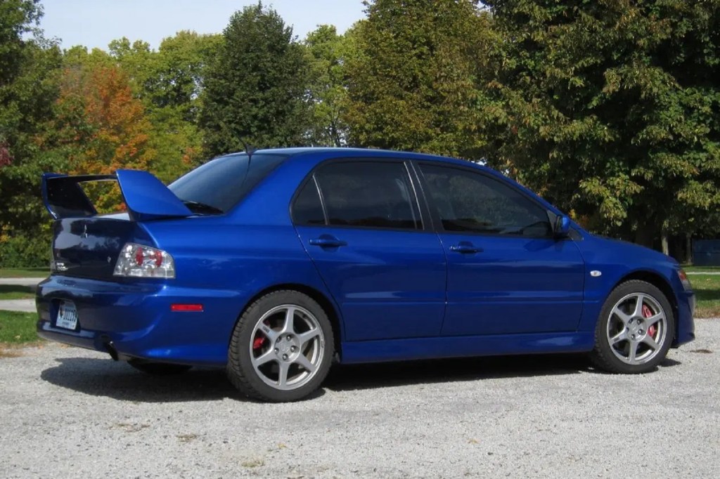 The rear 3/4 view of a blue 2005 Mitsubishi Lancer Evolution VIII