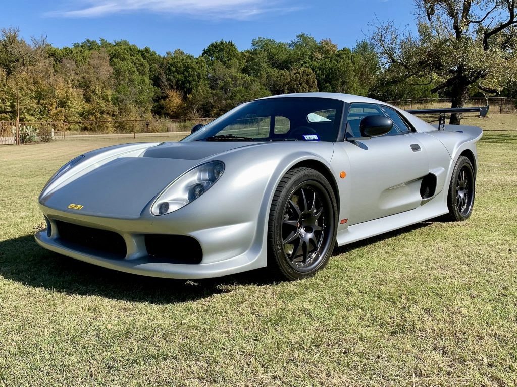 A silver 2005 Noble M400 in a field