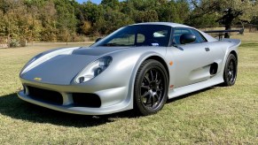 A silver 2005 Noble M400 in a field