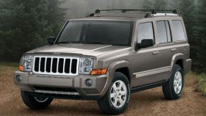 A tan 2008 Jeep Commander in the woods
