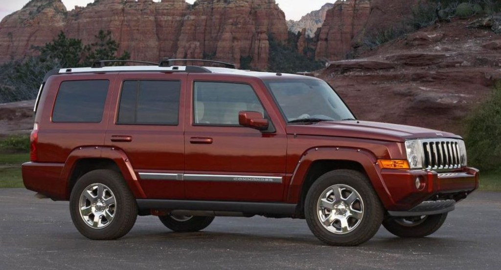 A burgundy 2008 Jeep Commander at the base of the Grand Canyon.