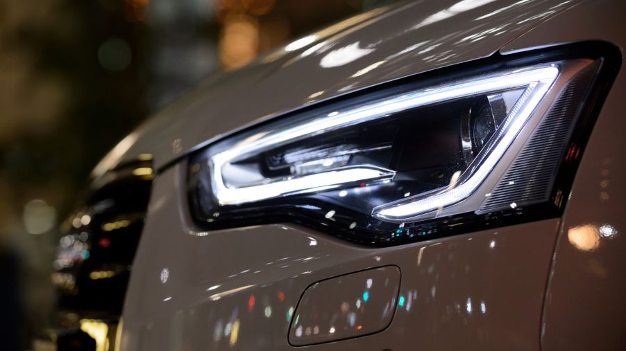 A close-up of a white 2015 Audi A5 Cabriolet's LED headlight