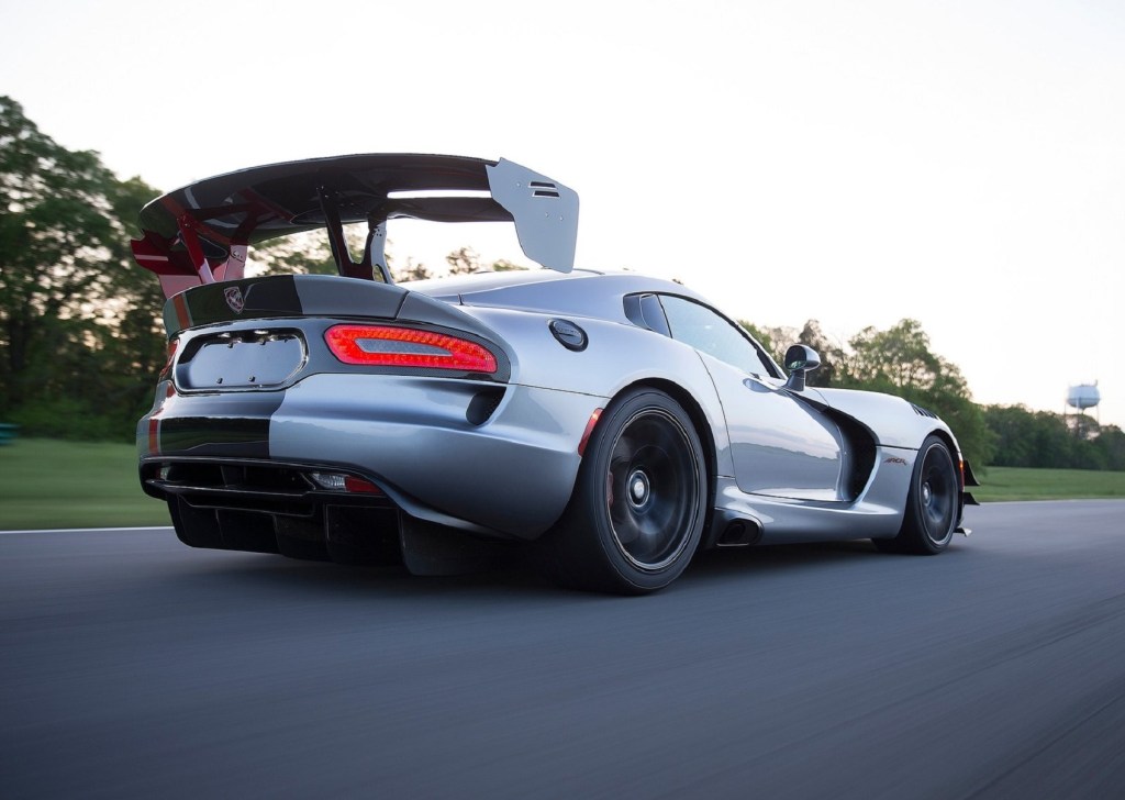 The low-angle rear 3/4 view of a silver 2016 Dodge Viper ACR and its wing