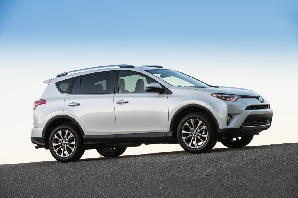 A silver 2017 Toyota RAV4 parked on display in front of a blue sky