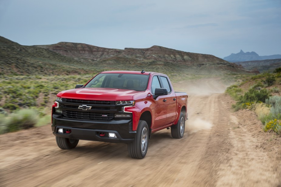 An image of a Chevy Silverado driving down a dirt road.