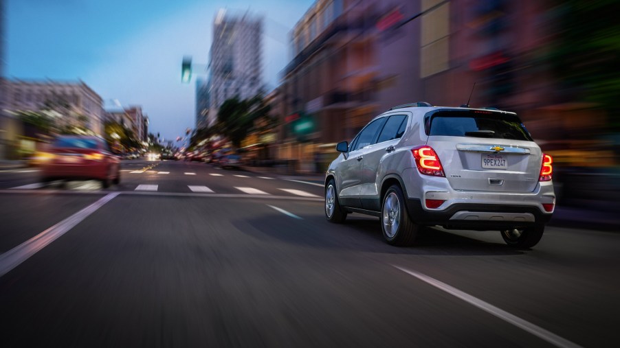 A silver 2020 Chevy Trax Premier travels on a city street